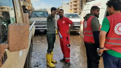 MediaageNG Derna: Flood-Hit Libyan City Living Through 'Doomsday' People in the flood-hit city of Derna are living through "doomsday", a Libyan reporter has told the BBC.