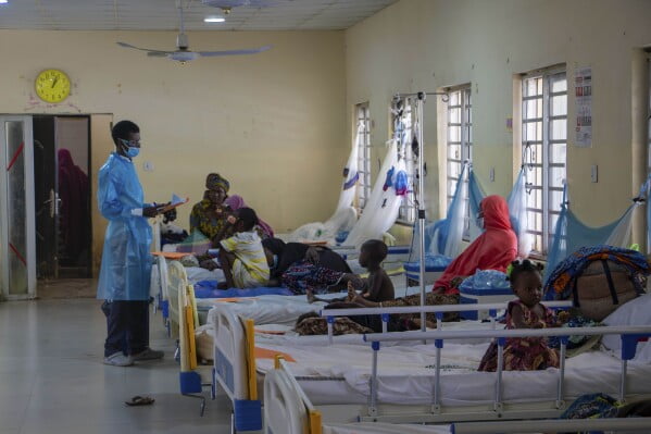 West Africa Responds To Huge Diphtheria Outbreaks By Targeting Unvaccinated Populations MediaageNG In this handout photo released by MSF, Dr. Aminu, left, on a routine check up on patients at the diphtheria treatment centre of the Murtala muhammad specialist hospital in Kano, Nigeria, Monday, Aug. 21, 2023. Authorities in several West African countries are trying to manage their huge diphtheria outbreaks, including in Nigeria where a top health official said Thursday Nov. 23, 2023 that millions are being vaccinated to cover wide gaps in immunity against the disease. (Ehab Zawati, MSF via AP).